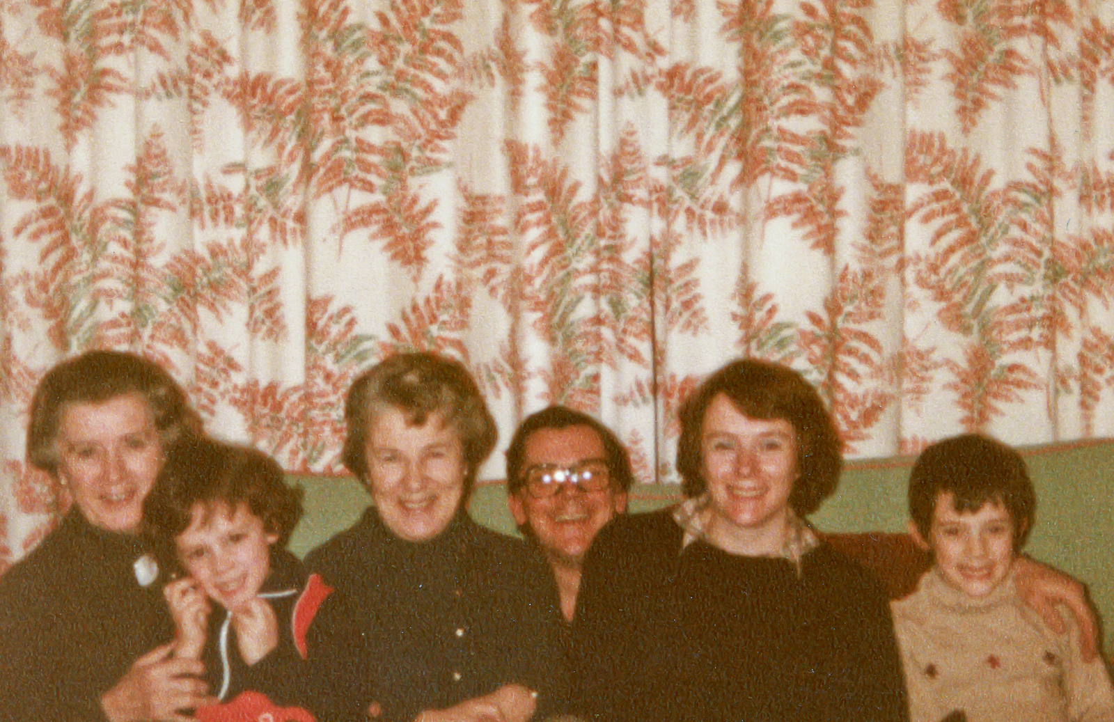 Family in 1980s crammed on sofa