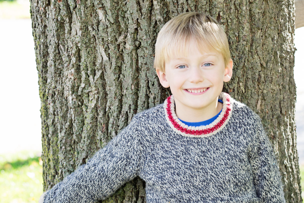 smiling boy on a tree