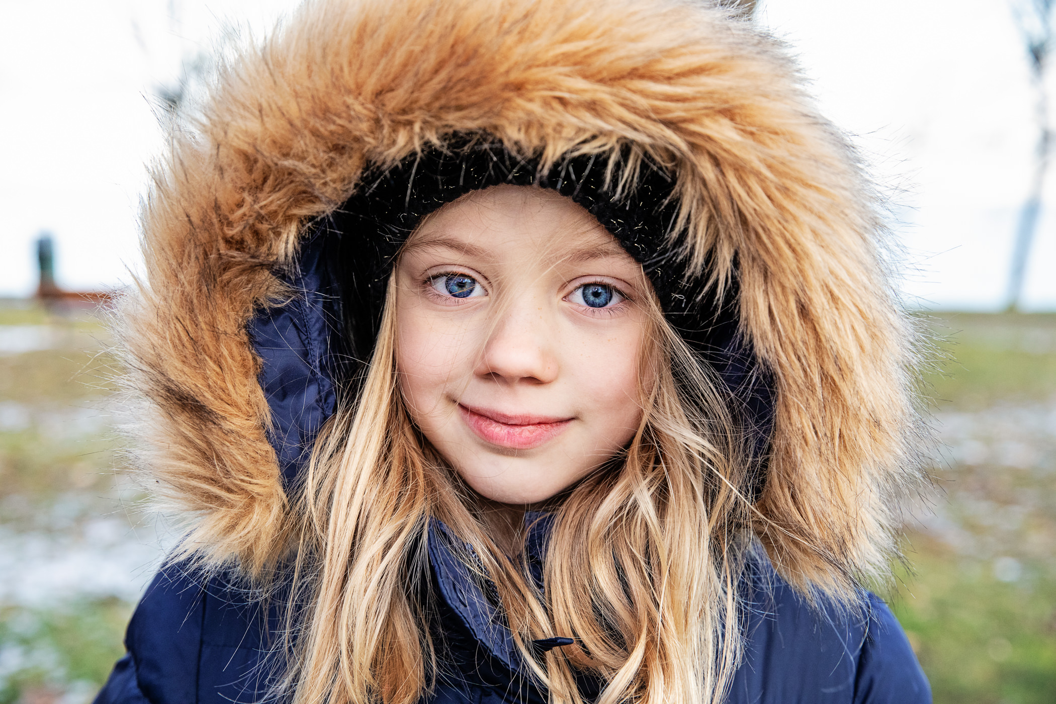 young girl in fur-trimmed hooded coat