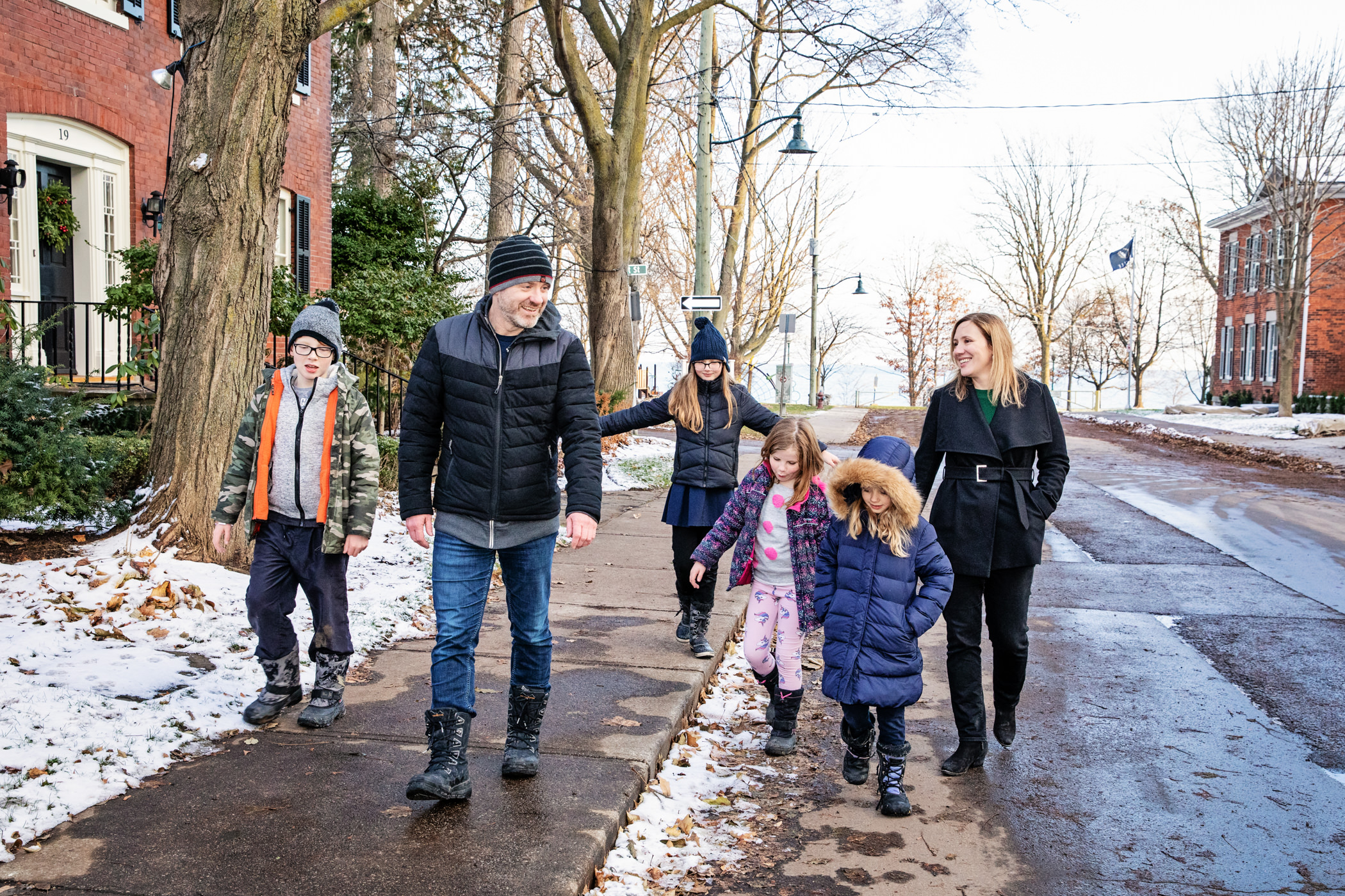 blended family walking on snowy street in oakville