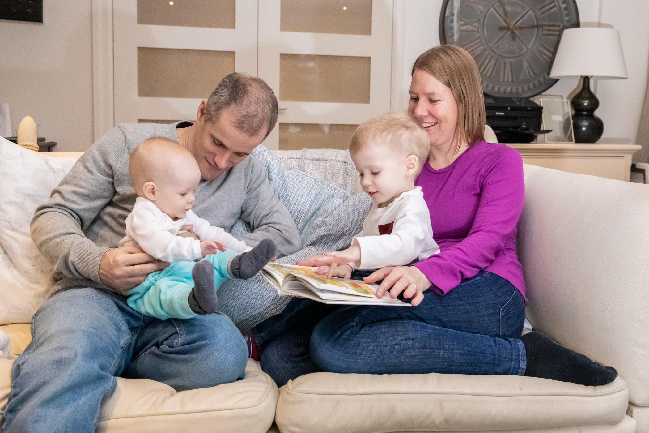 family reading together on couch